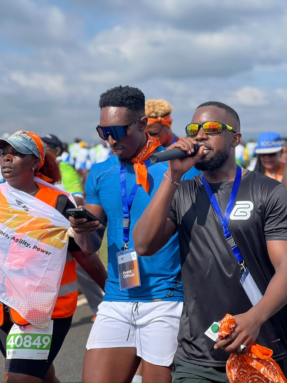 Dance Connect host speaking into microphone at Standard Chartered Marathon 2025